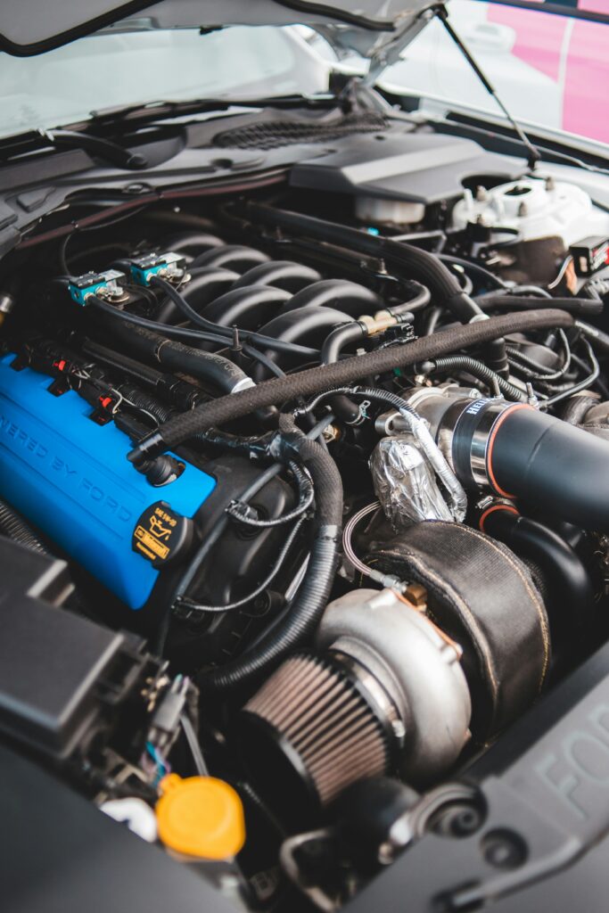 Detailed view of a modern car engine featuring a turbocharger, highlighting automotive engineering.